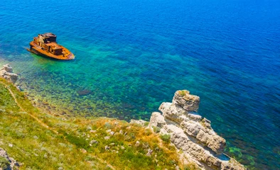 closeup shipwreck near a coast, summe sea transportation scene © Yuriy Kulik