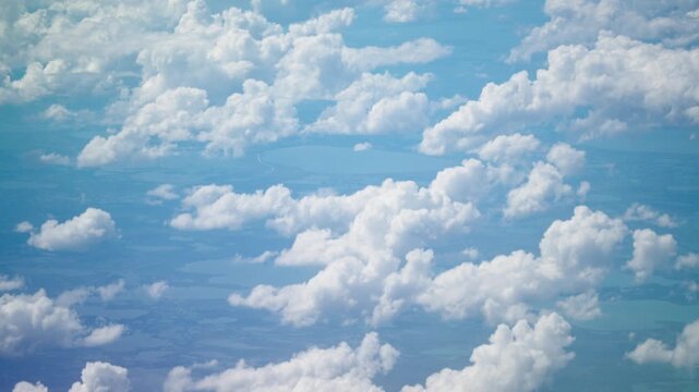 Aerial View of Scattered Cumulus Clouds over Blue Sky and Landscape