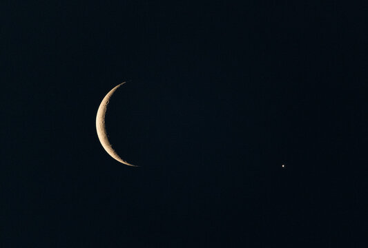 Astronomical alignment of crescent moon and bright venus in night sky