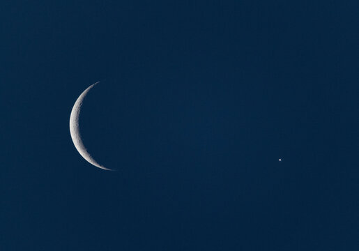 Space photo with celestial alignment of crescent moon and Venus