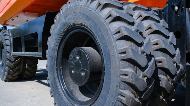 Close-up of two tractor tires on a construction site. Heavy-duty tires.