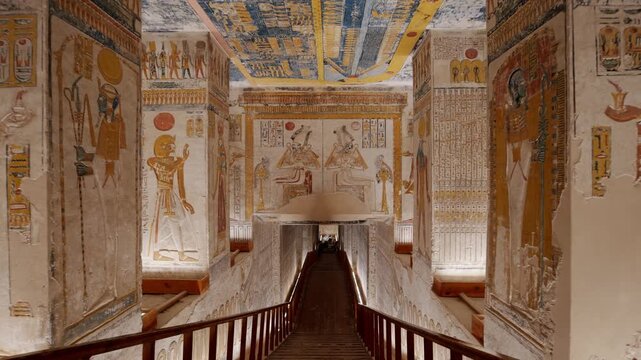 Descending staircase inside an ancient Egyptian royal tomb KV 9, Valley of the Kings, vibrant hieroglyphics and colorful walls and ceiling, Luxor, Egypt.