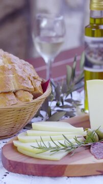 Served cheese with wine and bread on table