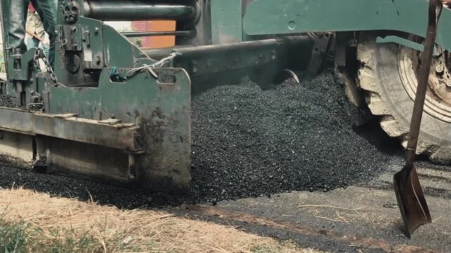 The asphalt paver is laying asphalt, Chiangmai Thailand.