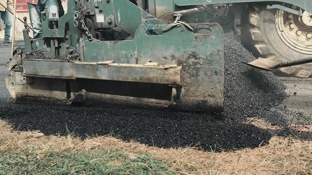 The asphalt paver is laying asphalt, Chiangmai Thailand.