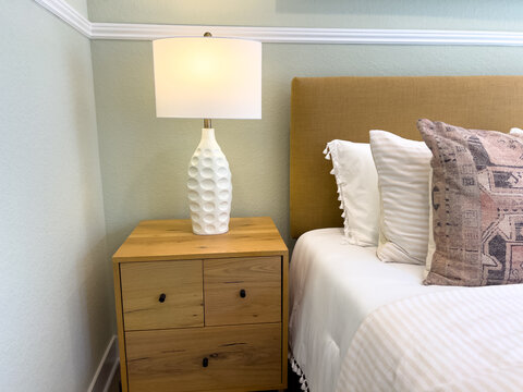 Bedroom nightstand with white lamp