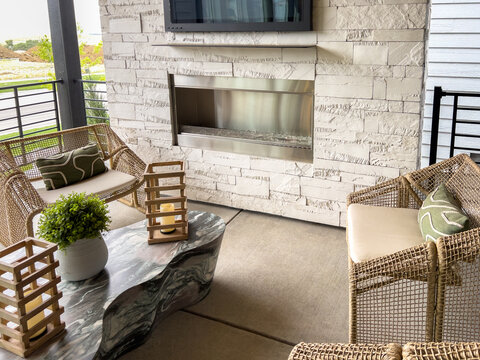 Covered Patio with Chairs Table and Stone Fireplace