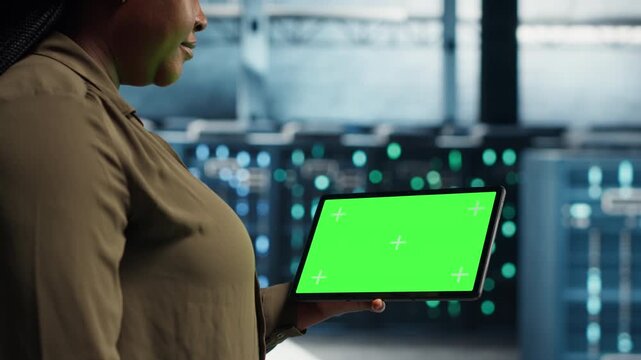 Woman watches digital video content near a video wall, suggesting streaming videos and online video platform.