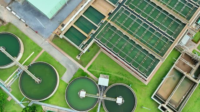 Aerial view captures a modern water treatment plant with circular clarifiers and filtration basins, representing wastewater management, environmental engineering, and sustainable urban infrastructure.