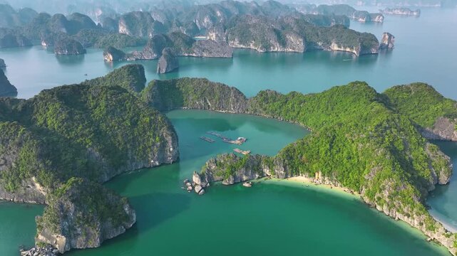 Aerial Drone View of Hidden Emerald Lagoon and Floating Fish Farm in Ha Long Bay Vietnam