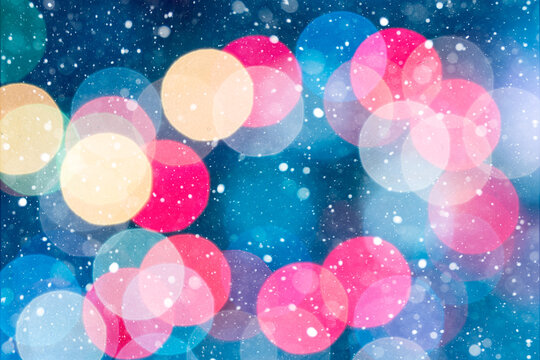 Colorful Christmas Bokeh Lights with Snow on Blue Background