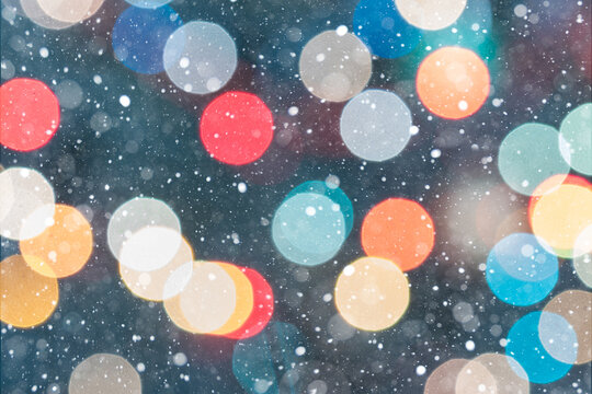 Multicolored Christmas Bokeh Lights on Dark Green Background with Snowfall