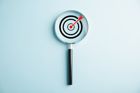 Target board inside magnifier glass for focus business objective