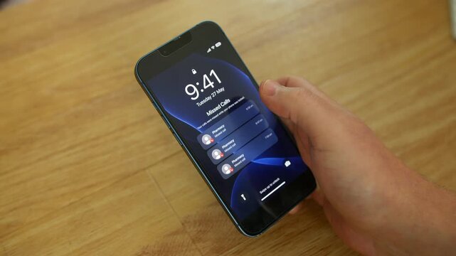 Missed calls from a Pharmacy appear on a smartphone lock screen while a person holds the device above a wooden table indoors. Phone notifications highlight prescription collection, medication reminder