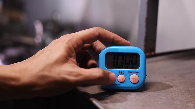 Hand setting time on a kitchen timer