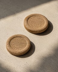 Obraz premium Professional photo of textured cork discs on sunlit surface with refined texture soft light and clean copy space for warm natural light background