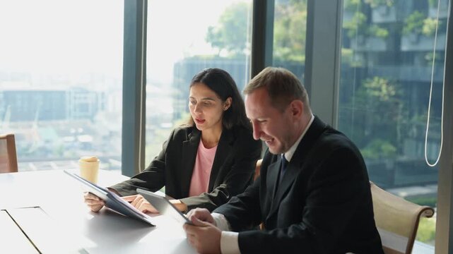 Business colleagues discussing project ideas during casual meeting in modern office, sharing updates, solving problems and planning next steps through professional teamwork and communication.