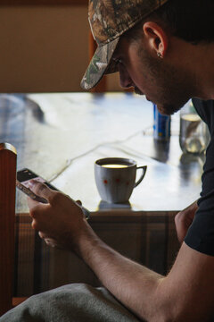 man drinking coffee with mobile phone