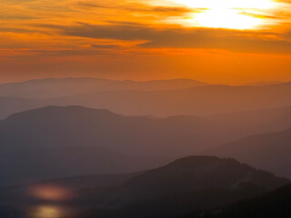 Naklejka premium Golden sunset over layered mountain ridges in Carpathian mountains Ukraine