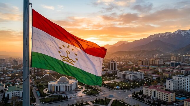 Waving Flag of Tajikistan Over Dushanbe Cityscape at Sunset with Mountain Background View