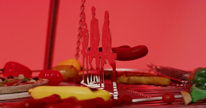 Animated figures of people silhouetted against a red background above a circular barbecue grill