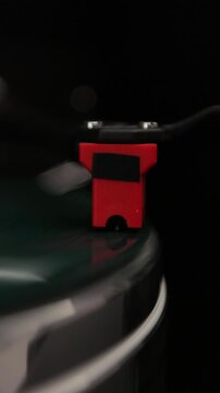 Vertical video Close-up of a vinyl record and a turntable needle. Vintage vinyl record player.