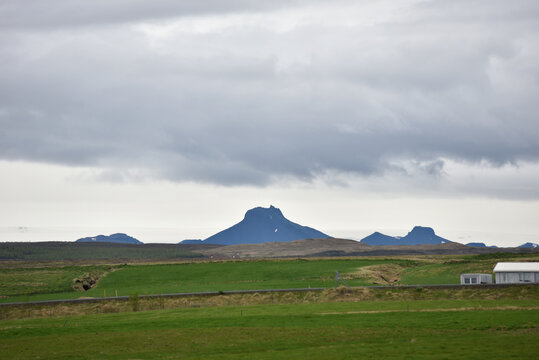Majestic peak of Stora Jarlhetta rising beyond green fields, Iceland