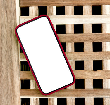 Angled smartphone mockup with green screen on a wooden lattice background. Modern mobile template with copy space for app design and advertising. Blank phone display for branding