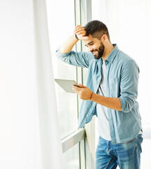 Fototapeta premium Portrait of a young man with a tablet