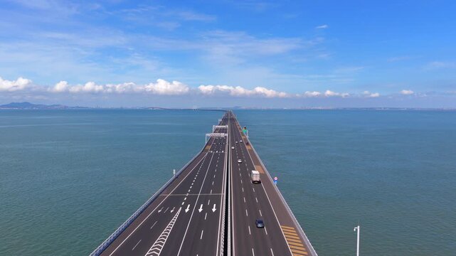 Aerial drone view of Jiaozhou Bay Cross Sea Bridge in Qingdao, coastal traffic infrastructure over sea water，Drone shot of multi-level sea interchange bridge with moving vehicles, Jiaozhou Bay Qingdao