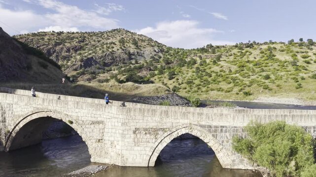 Cinematic View of Historic Kasrik Bridge in Siirt, Turkiye &ndash; Stone Arch Bridge Over Botan River and Anatolian Heritage