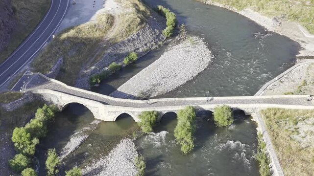 Cinematic View of Historic Kasrik Bridge in Siirt, Turkiye &ndash; Stone Arch Bridge Over Botan River and Anatolian Heritage