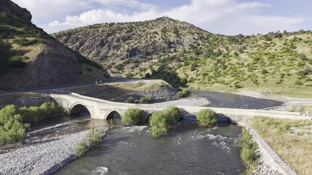 Cinematic View of Historic Kasrik Bridge in Siirt, Turkiye &ndash; Stone Arch Bridge Over Botan River and Anatolian Heritage