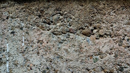 Concrete Building Material with Rough Textured Surface and Visible Stones © NOVRIN