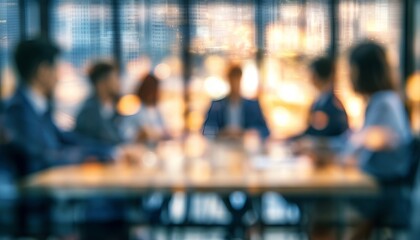 Fototapeta premium Blurred office team collaborating and sharing ideas around a conference table in a modern setting