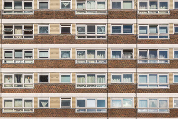Fototapeta premium Council apartment block facade with repeating windows on the York Way Estate in Islington, London, UK