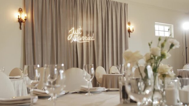 Beautifully arranged wedding reception featuring floral centerpieces, elegant table settings, and soft lighting, creating a romantic atmosphere for guests