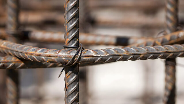 Reinforced steel bars tied together with metal wire at a construction site
