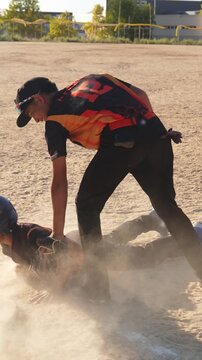 Slow motion of a young shortstop making a double play by tagging the runner sliding into second base and then throwing the ball to first