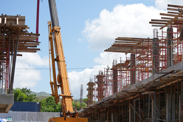 Mobile crane working on a large multi story construction project © ThomX Design