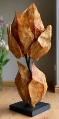 Fototapeta premium Artistic Hand Crafted Wooden Sculpture Featuring Organic Leaf Forms Mounted On A Sturdy Base Stand.