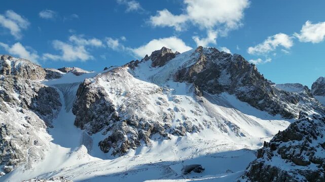 Aerial View of Glaciated Peaks and Snow Covered Alpine Valley in the Tien Shan Mountains at Shymbulak, Kazakhstan