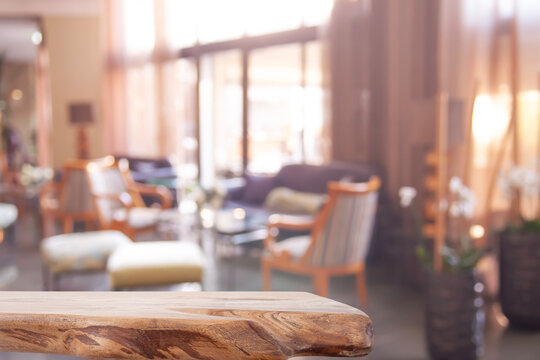 Empty wood table for product display on blurred hotel hall background offering inviting atmosphere