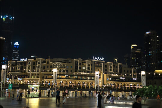 Dubai, UAE - June 16, 2026: Night View Of Emaar Building Along The Waterfront With People In Downtown Dubai