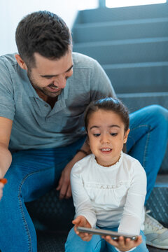 Father and daughter spending time using digital tablet