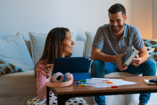 Couple sharing space working and reading at home