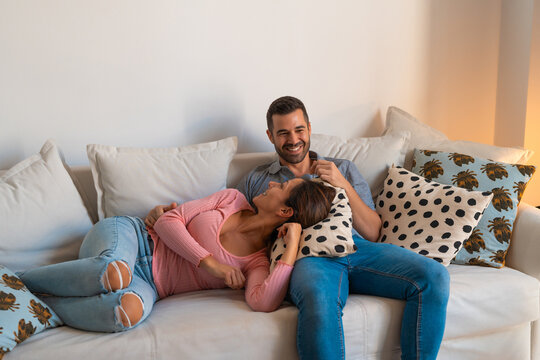 Couple in love lying on the sofa during movie night