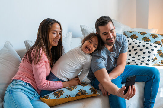 Joyful family taking a selfie together at home