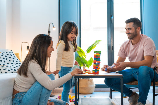 Cute family playing block game in the living room