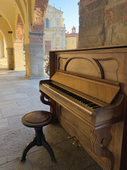 an old piano under the arcades of the main square of Mondovì © Daniele